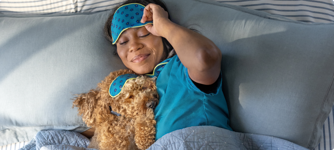 Sahibiyle birlikte yatakta dinlenen köpek